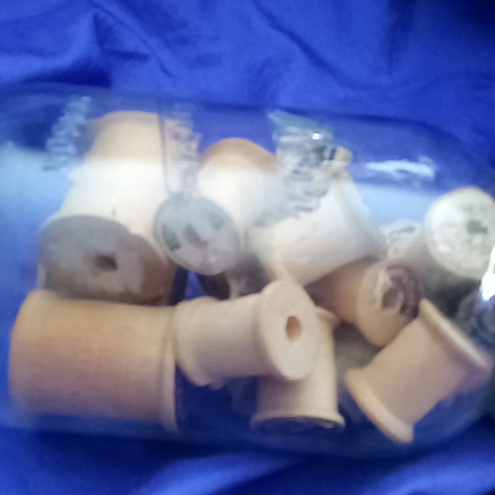 Vintage kerr Mason jar with 25 vintage wooden thread spools and a zinc l…